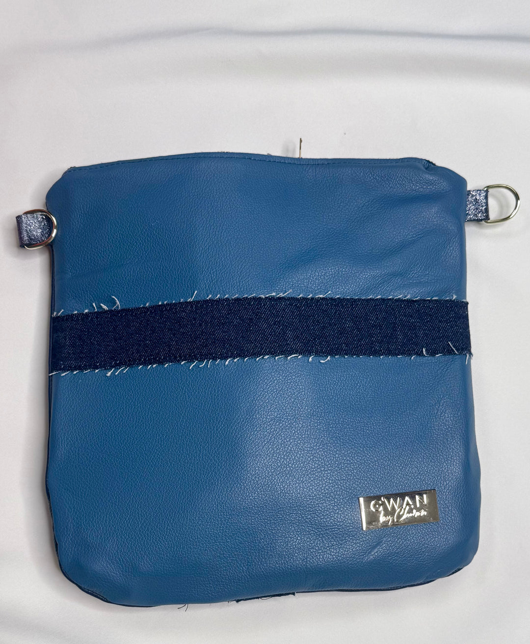 Blue pouch with a black strap on a white background