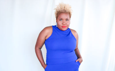 Person wearing a blue jumpsuit against a white background