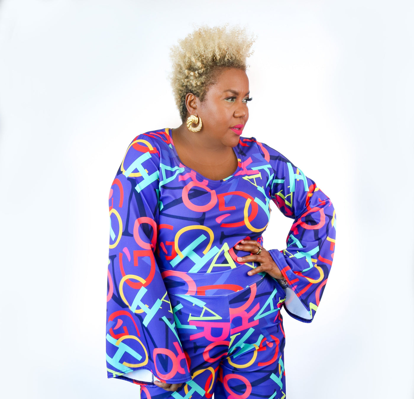 Person wearing a colorful outfit with abstract patterns on a white background