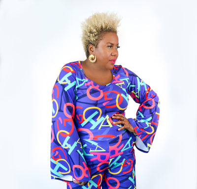 Person wearing a colorful outfit with abstract patterns on a white background